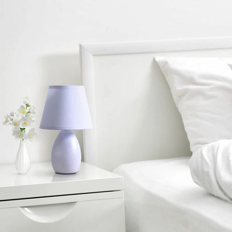 Bedroom scene with Super Cute Mini Blue Egg Oval Ceramic Table Desk Lamp With Matching Fabric Shade on white nightstand.