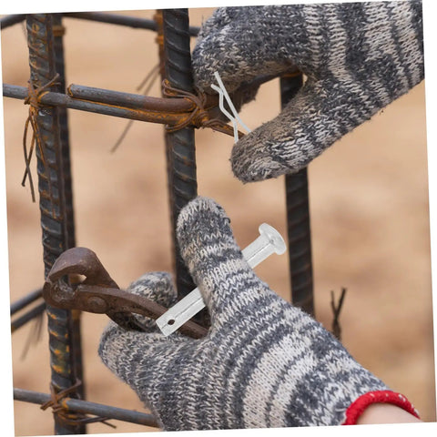 Gloved hands using scaffolding coupling pins and locking retainers for fast easy scaffold assembly on rebar construction site