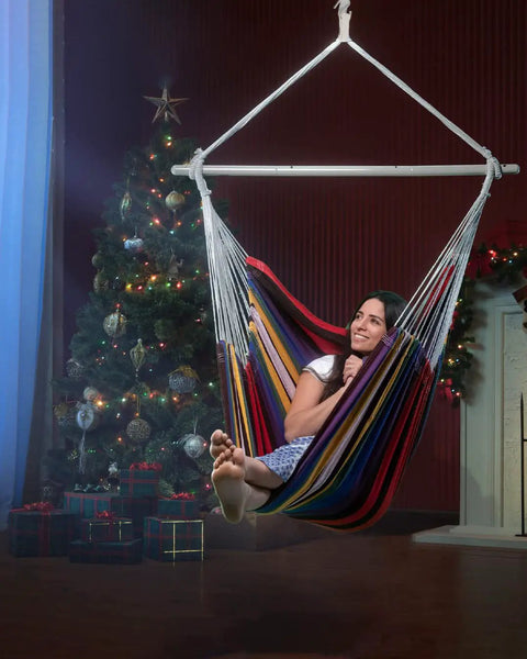 Indoor view of Oversized Hammock Chair With Rope Swing And Two Cushions, 500 Lb Capacity For Indoor Outdoor Relaxation, Rainbow design.
