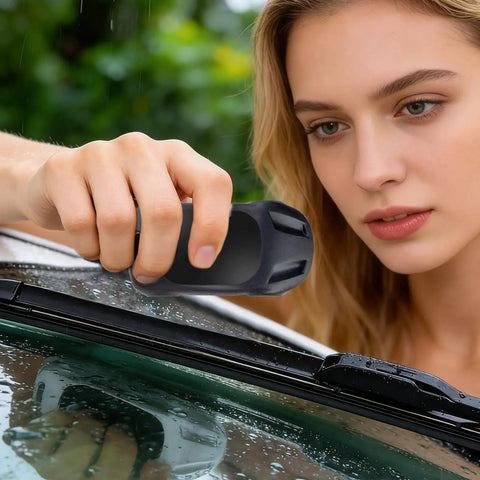 Woman using a Windshield Wiper Repair Tool Quick Fix Automotive Restorer For Cars on a wet car windshield.