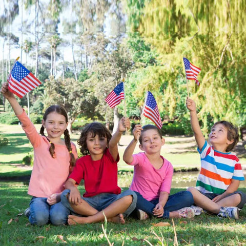Children holding Six Pack 4x6 Inch Small American Flags On Wooden Sticks Handheld USA Flags with Kid Safe Spear Top for Outdoor Use