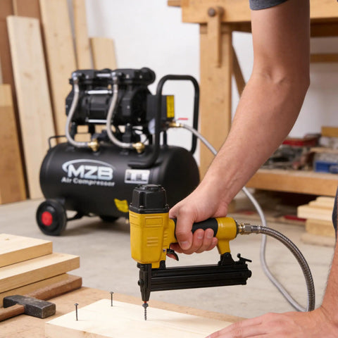 Person using nail gun connected to 6.4 Gallon Ultra Quiet Air Compressor With Steel Tank And Wheels Oil Free 70 Decibels 110V