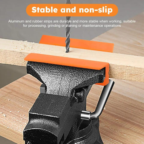 Heavy Duty 4 Inch Vise Jaw Pads With Magnetic Soft Jaw Covers For Bench Vise Replacement mounted on wooden plank, showing stable grip.