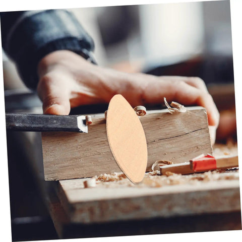 Close-up of a 100Pcs Wood Joining Biscuits Set For Rock Solid Furniture Joints, showing a light yellow biscuit and woodworking process.