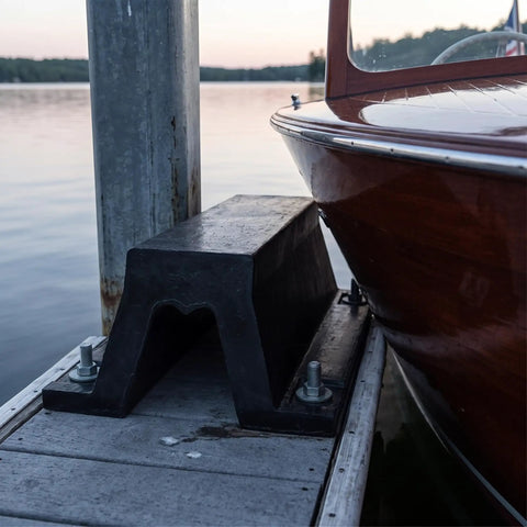 Arch Rubber Dock Shield for Dock Protection From Boat Impacts installed on dock, next to a wooden boat hull.