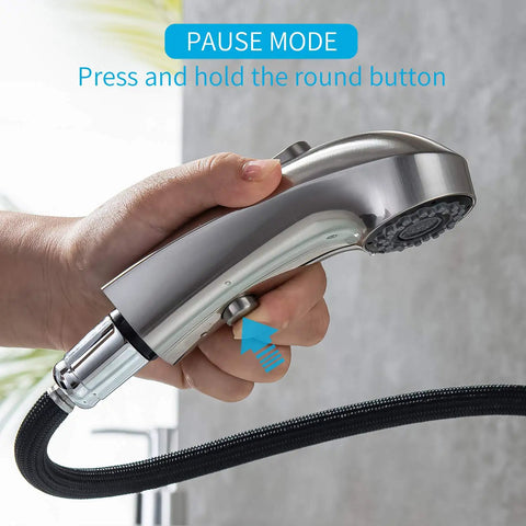 Close-up of hand holding the Brushed Nickel Pull Out Bathroom Faucet With 3 Spray Modes Single Hole Sink Faucet Pull Down Sprayer in pause mode.