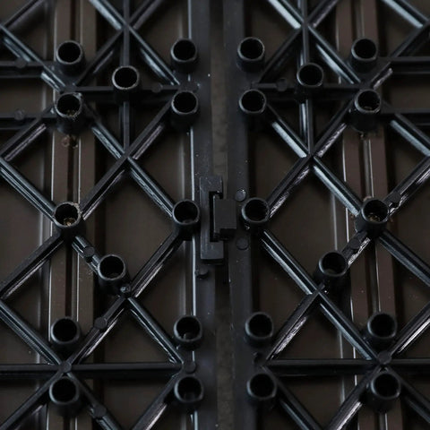 Close-up of the interlocking system on 12x12 wood plastic composite deck tiles for indoor and outdoor water resistant flooring.