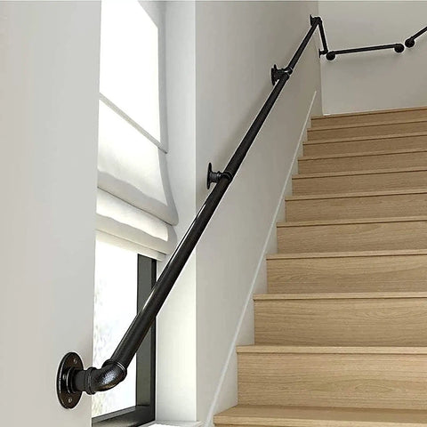 Badass Industrial Wrought Iron Stair Railing Kit Twenty Foot Wall Mount Banister Pipe Rail along wooden stairs with window.