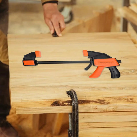 Heavy Duty Woodworking Bar Clamps With Quick Release on wooden workbench, featuring steel construction and TPR jaws, no screwdriver needed.