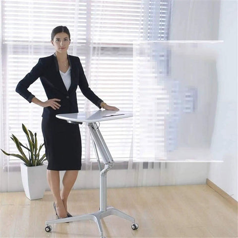Plug And Play Adjustable Laptop Desk Featuring A Rock Solid Portable Rolling Stand for sit-stand use in a modern office setting.