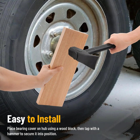 Installing 4 Pack 1.98 Inch Trailer Wheel Bearing Protectors with a wooden block and hammer on a trailer hub.
