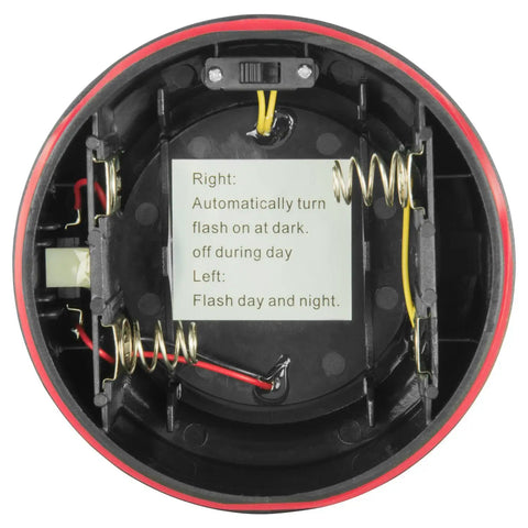 Interior view of Badass Led Amber Warning Beacon With Rock Solid Magnetic Base showing battery compartment and flash mode instructions.