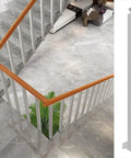 Premium Side Mount Stair Railing Spindles Thirty Pack With Screw Kit And Pre Drilled Holes For Decks Porches And Railings No Sweat Set Up Super Durable Steel Balusters three feet tall displayed in a modern staircase.