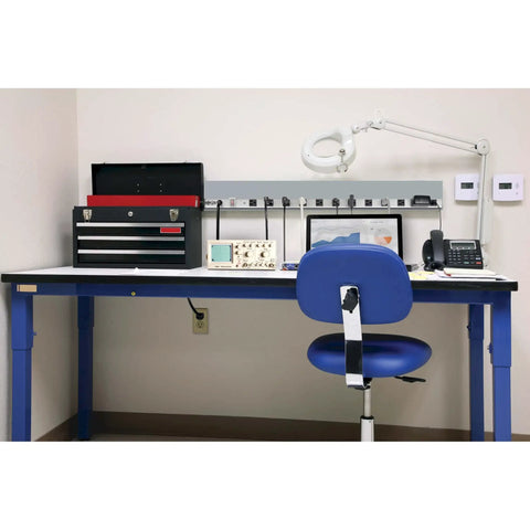 Workbench setup with Twelve Outlet Power Strip with Surge Protection, 15 Foot Cord, Heavy Duty Metal, 36 Inch Long, visible on wall.
