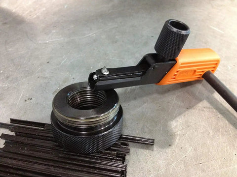 External And Internal Adjustable Thread Restorers Universal Thread Repair Tool Kit in use on metal surface.