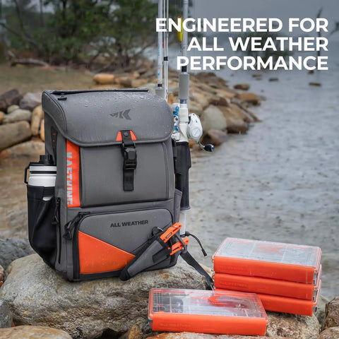 All Weather Fishing Tackle Backpack with four waterproof tackle boxes and removable rod holders on rocky shore.
