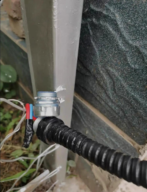 Heavy Duty Flexible Metal Conduit Corrugated Electrical Hose With Pvc Coated Wire Protection Tube One Hundred Meter Roll connected to metal fitting.