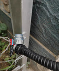 Close-up of Heavy Duty Flexible PVC Coated Metal Conduit with corrugated sleeve attached to a metallic fixture.