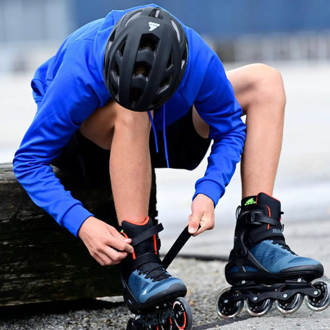 Person fastening Macroblade 90 Inline Skates For Adults Unisex Orion Blue And Sharp Orange Size 270 on foot, elevated cuff visible