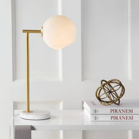 Gold And White Modern Metal Marble LED Bedside Lamp With Frosted Glass Globe Shade Sleek Minimalist Scandinavian Style For Bedroom And Living Room Includes Energy Saving LED Bulbs ETL Listed on white table.