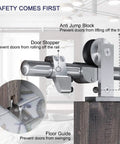 Close-up of safety features on Top Mount Sliding Barn Door Hardware Kit in Stainless Steel, showing stopper and guide