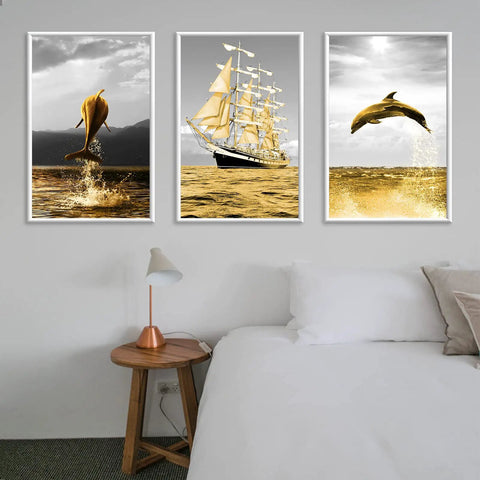 Golden dolphin and sailing ship artwork above modern bedroom side table