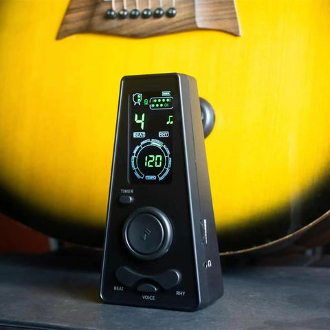 Digital Metronome For Piano Guitar Violin Ukulele Cello Flute With LED Display Rotary Tempo Knob in front of a guitar