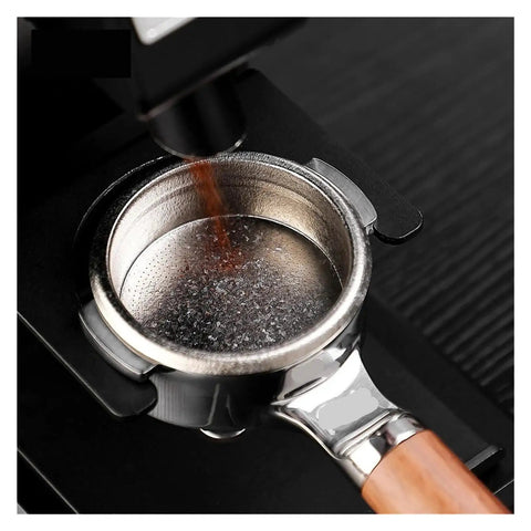 Premium Titanium Portafilter Basket 58.5mm Holds 18 To 20 Grams with coffee grounds pouring in.