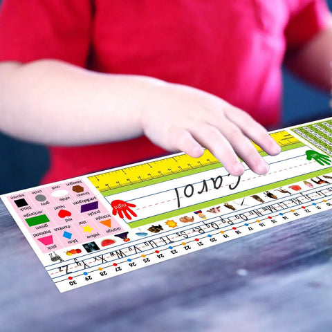 Child placing Self Adhesive Desk Nameplates Set for Primary Students Pack of 36 on desk; bright colors with alphabet, shapes.