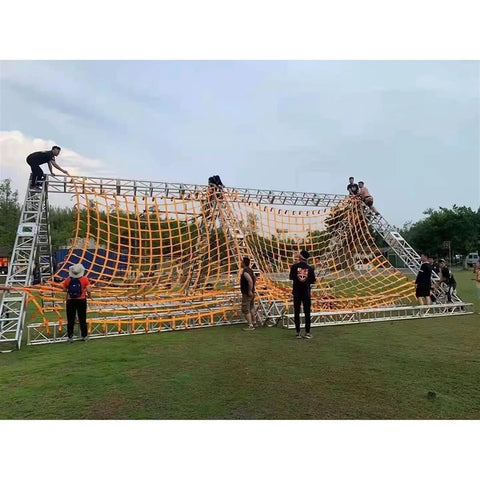 People climbing on a structure with a Beefy Heavy Duty Polyester Lifting Net For Cargo, Garden And Industrial Tasks stretched over it.