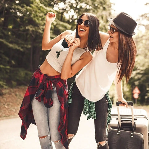 Two people outdoors with luggage; concept of travel and adventure