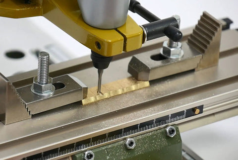 Close-up of Micro Compound Table KT 70 with adjustable ruler and clamp kit, showcasing precise alignment on drill press.