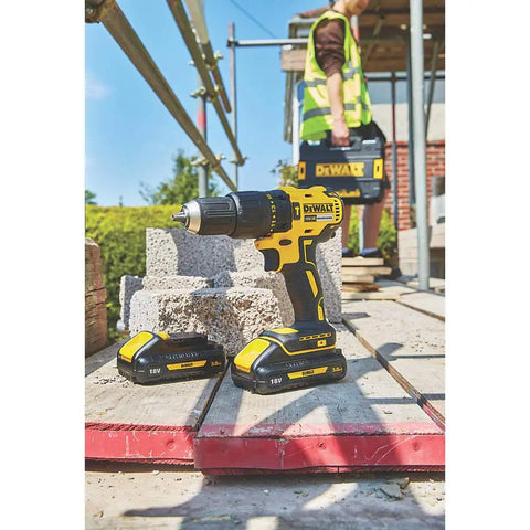 Heavy Duty 18V Cordless Hammer Drill Brushless Motor Kit With Two 3.0 Ah Lithium Ion Batteries and Compact Design on a construction site.