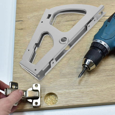 Installing stainless steel cabinet hinges with a drill for easy door attachment.