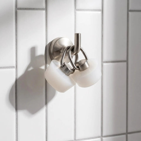 Stainless Steel Ring White Drain Stopper Silicone for Sinks on a wall hook, featuring two silicone stoppers for easy access.
