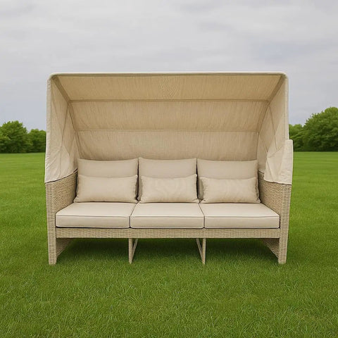 Top Shelf Wicker Patio Couch With Cabana Canopy And Ottoman Set Featuring Three Seat Bench Plus Coffee Table For Chill Backyard Hangouts With Zero Stress in beige on grass.