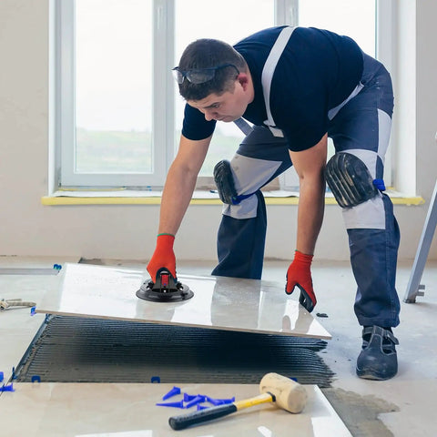 Professional Grade Eight Inch Glass Suction Cup Lifter Built With Manual Vacuum Pump in use on large tile panel installation.