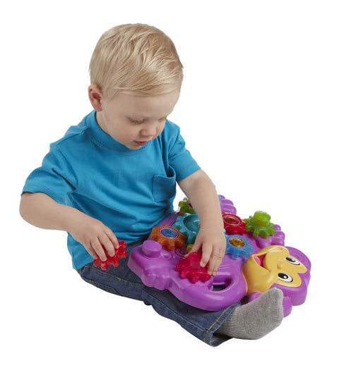 Child playing with Totally Awesome Dope Monkey Gears Stacking And Spinning Toy with colorful cogs on a sturdy base.