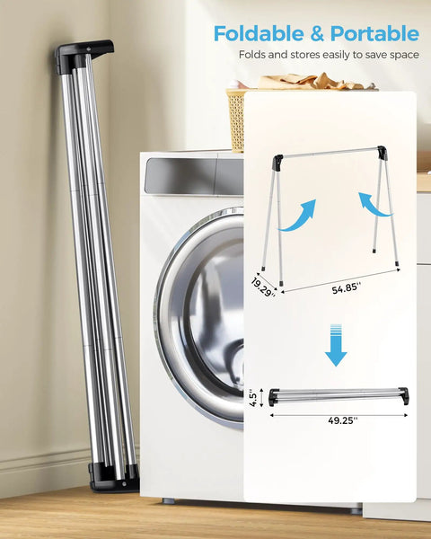 Foldable Clothes Drying Rack Portable Laundry Stand Sturdy Hanging Bars Compact Airer For Apartments Dorm Rooms Closets Quick Dry Setup Zero Fuss Easy Everyday Storage next to a washing machine, showcasing its foldable feature.