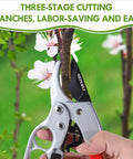 German Made Pruning Shears For Precision Cutting being used on a tree branch in garden, showcasing three-stage cutting, ergonomic grip.