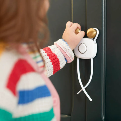 Child using OutSmart Flex Lock Childproof Cabinet Locks White 2 Pack With Decoy Button And Flexible Design No Drill Install