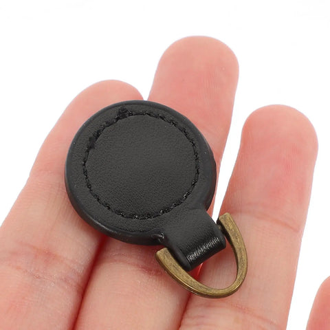 Top Level Black Aluminum Zipper Pull Tabs For Backpacks And Travel Luggage Smooth Glide Heavy Duty Replacement Hardware Zero Stress DIY Quick Upgrade Set held in hand.