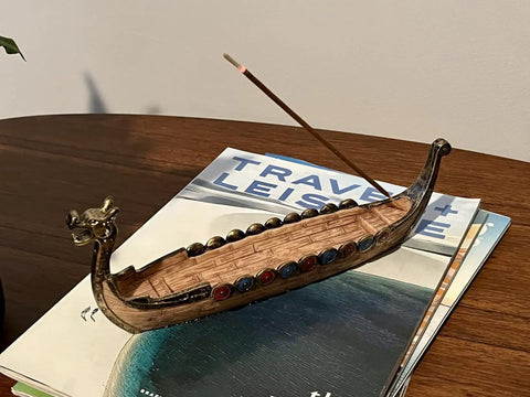 Hand Carved Dragon Boat Incense Burner With Traditional Chinese Design incense stick holder on a wooden table.