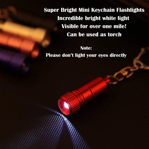 Red keychain flashlight emitting bright light, showcasing Ten Pack Mini LED Keychain Flashlights With Hooks For Camping And Grab And Go Everyday Carry, Ultra Compact 4 Cm Size, Battery Included, Five Color Assortment With Two Per Color, Travel Ready Night Light For Spontaneous Runs And Quick Fixes.