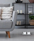 Dual Pop Up Floor Box Kit With 20A Tamper Resistant Duplex Outlet And 3 Port RJ45 Datacom Receptacle in brushed nickel under sofa
