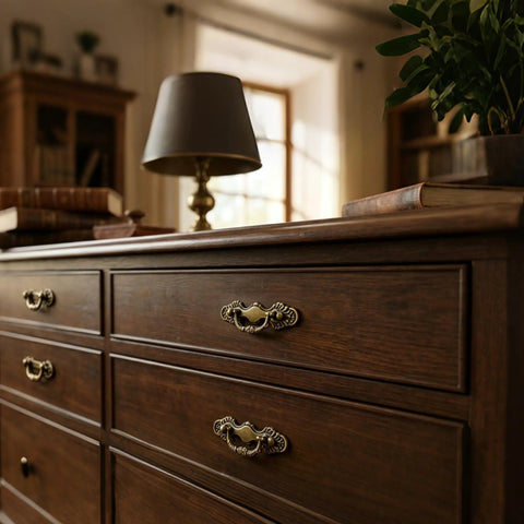 4 Pack Antique Brass Bail Drawer Pulls With 2-1/2 Inch Center Spacing on wooden dresser in living room