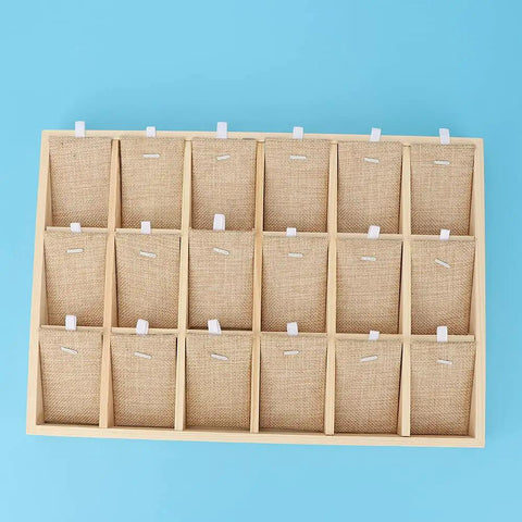 Top Tier Solid Pine Wooden Jewelry Display Tray With 18 Grid Slots And Ultra Plush Velvet Lining For Necklaces Bangles Rings on blue background.