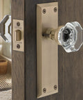 Crystal Door Knob With Back Plate In New York And Waldorf Style on wooden door, vintage glass knob and brass plate.