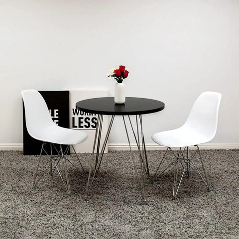 Minimalist round black table with white chairs, suitable for use with Black 3/4 In X 100 Ft Center Barb Tee Molding Roll for DIY projects.