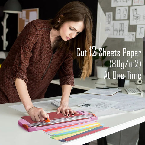Woman using 12 Inch Titanium Paper Cutter With Side Ruler For Scrapbooking And Crafting No Fuss Paper Trimmer Guillotine For A4 A5 Cardstock Photos Coupons Labels Pink on desk